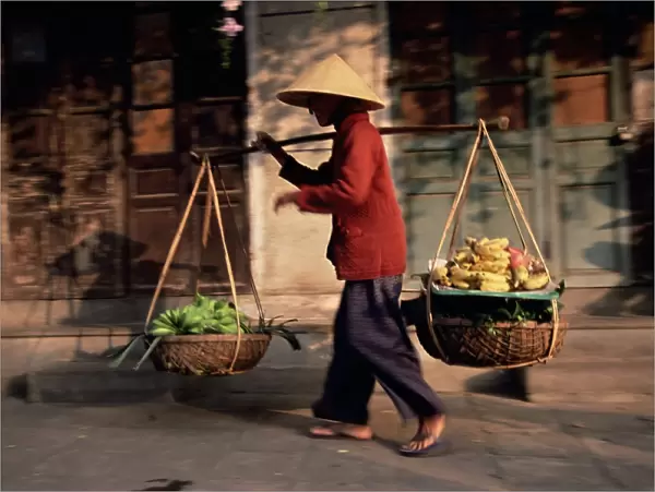 Woman carrying fruit and vegetables