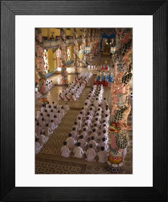 Framed Print : Rows of monks at prayer inside a temple of the Caodai religious sect Framed Print : Rows of monks at prayer inside a temple of the Caodai religious sect