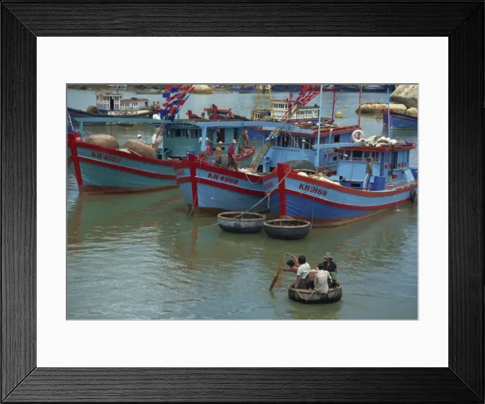 Framed Print : Men in Thung Chai basket boat paddle to boats at Nha Trang in Vietnam Framed Print : Men in Thung Chai basket boat paddle to boats at Nha Trang in Vietnam