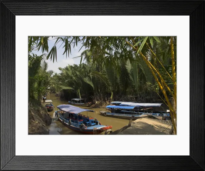 Framed Print : Navigating the waterways amid coconut palm trees Framed Print : Navigating the waterways amid coconut palm trees