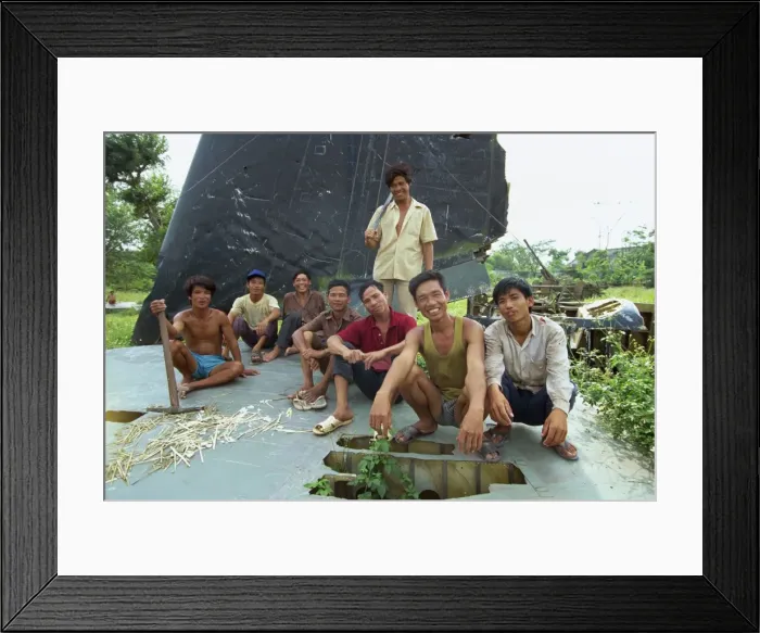 Framed Print : A group of smiling park workers on the tail plane of Framed Print : A group of smiling park workers on the tail plane of