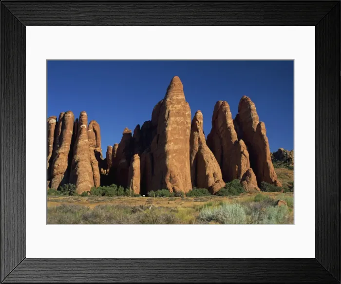 Framed Print : Hikers dwarfed by sandstone fins near Devils Garden Framed Print : Hikers dwarfed by sandstone fins near Devils Garden