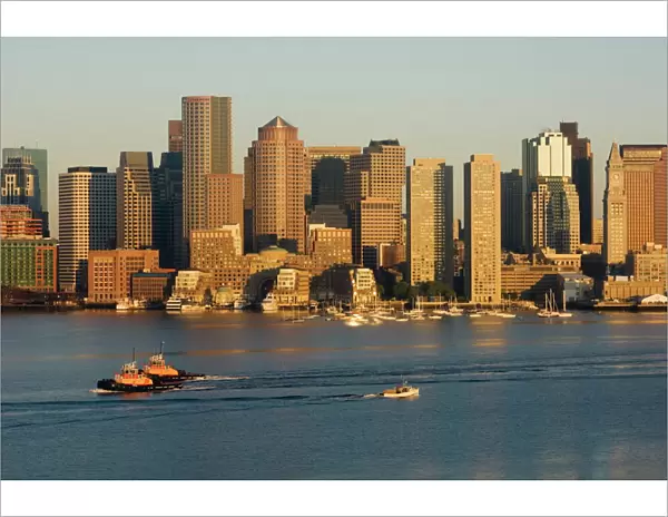 City skyline at dawn across Boston Harbor