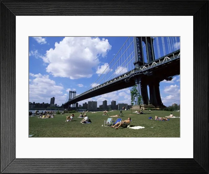 Framed Print : People sunbathing at a park in Brooklyn under the Manhattan Bridge