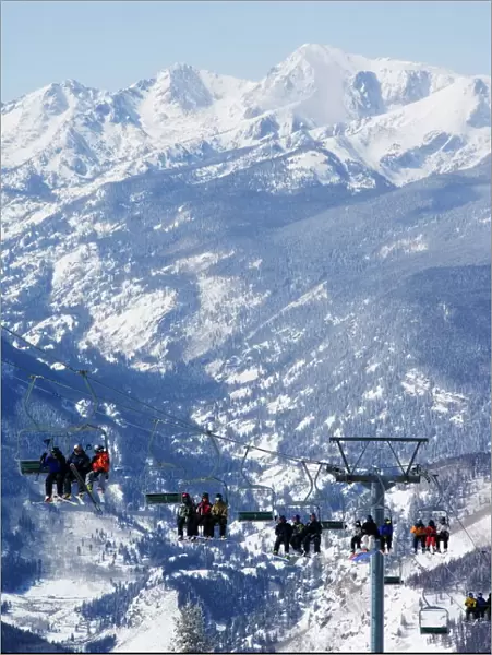 A chairlift taking skiers to the back bowls of Vail ski resort