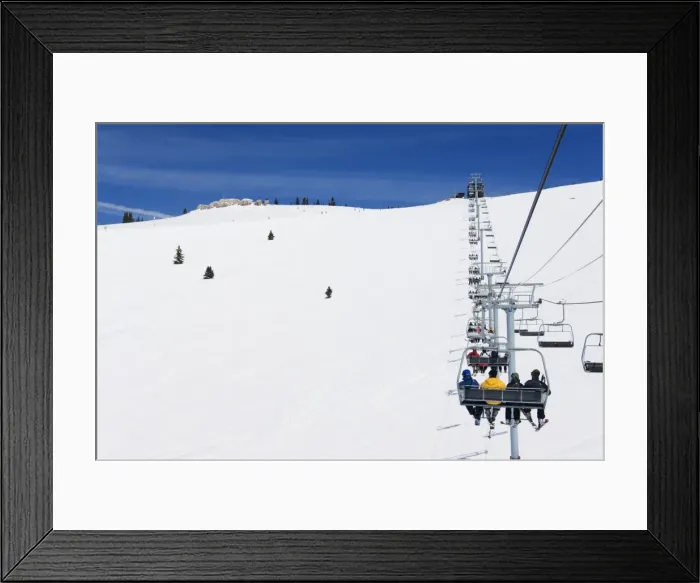 Framed Print : Skiers being carried on a chair lift to the back bowls Framed Print : Skiers being carried on a chair lift to the back bowls