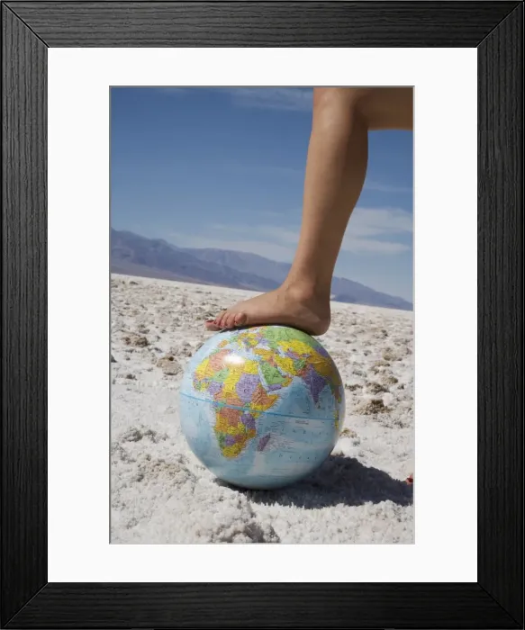 Framed Print : Womans foot on globe Framed Print : Womans foot on globe