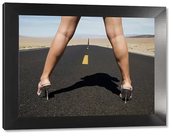 Woman in high heels on empty road
