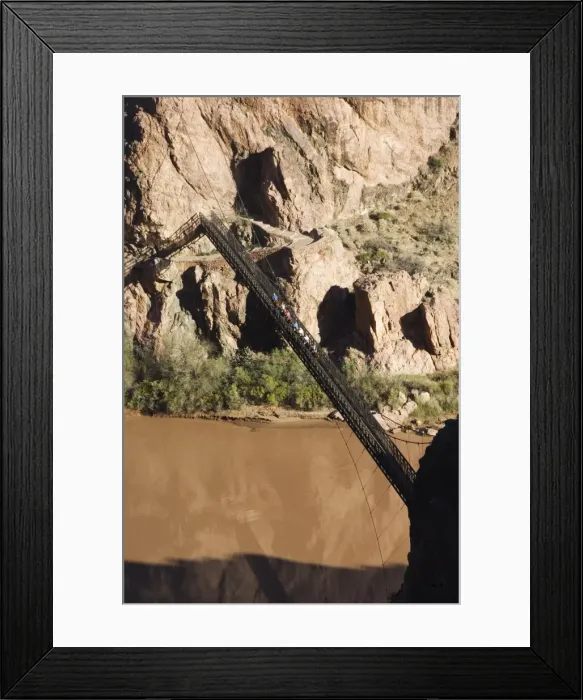 Framed Print : Horses and tourists crossing a suspension bridge spanning Framed Print : Horses and tourists crossing a suspension bridge spanning