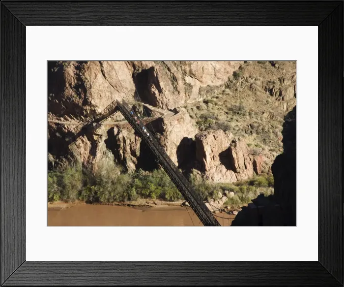 Framed Print : Horses and tourists crossing a suspension bridge spanning Framed Print : Horses and tourists crossing a suspension bridge spanning