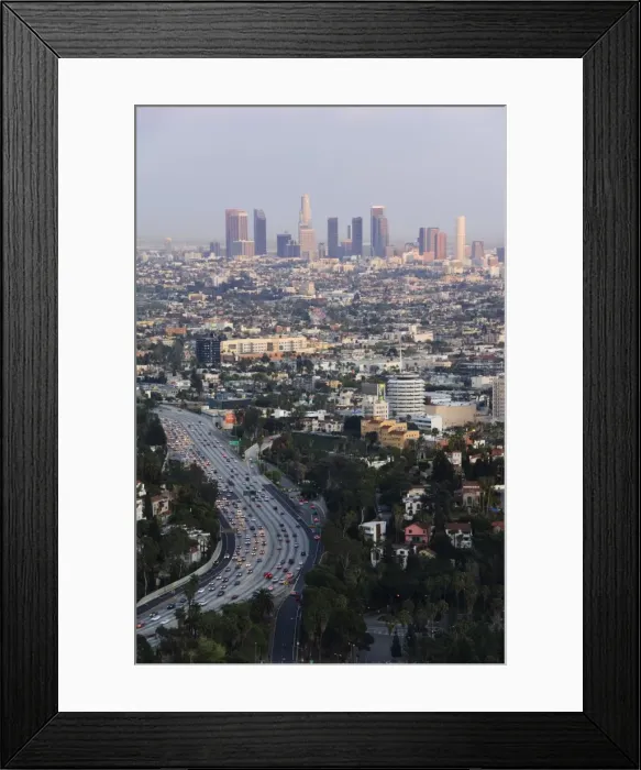 Framed Print : Downtown district skyscrapers and cars on a city highway Framed Print : Downtown district skyscrapers and cars on a city highway