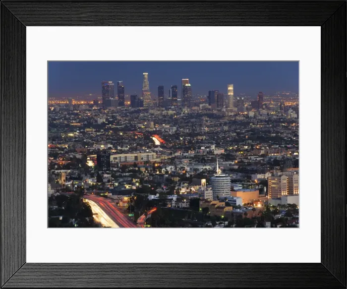 Framed Print : Downtown district skyscrapers and car lights on a city highway Framed Print : Downtown district skyscrapers and car lights on a city highway