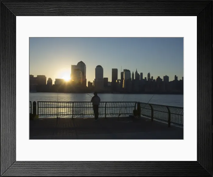 Framed Print : Fisherman fishing from a Jersey City pier at dawn facing Framed Print : Fisherman fishing from a Jersey City pier at dawn facing