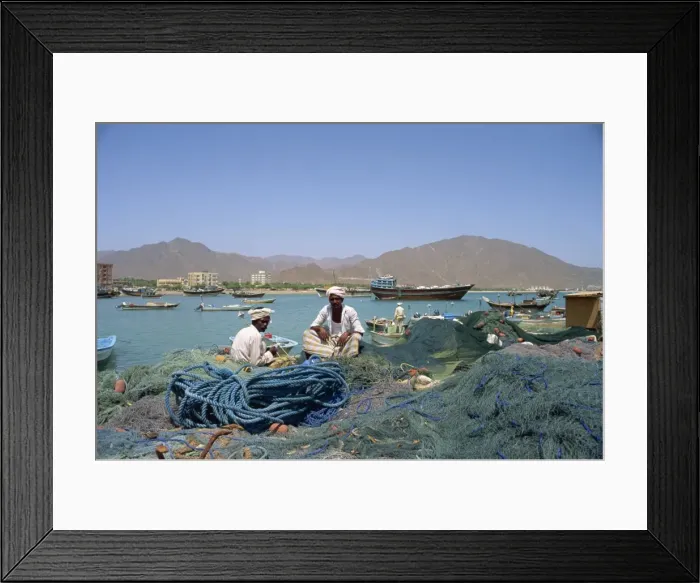 Framed Print : Men sitting amongst fishing nets at dockside Framed Print : Men sitting amongst fishing nets at dockside