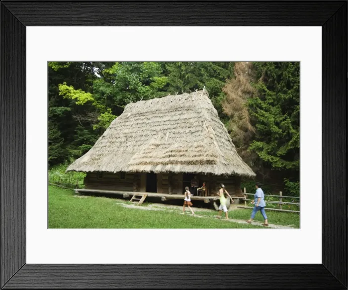 Framed Print : Tourists visiting traditional thatched roof house in Framed Print : Tourists visiting traditional thatched roof house in