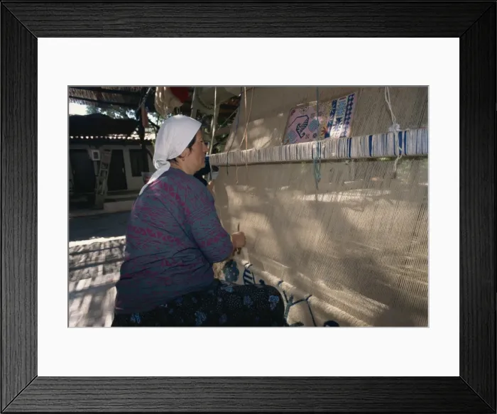 Framed Print : Woman weaving wool carpet on a loom in a workshop at Kusadasi Framed Print : Woman weaving wool carpet on a loom in a workshop at Kusadasi