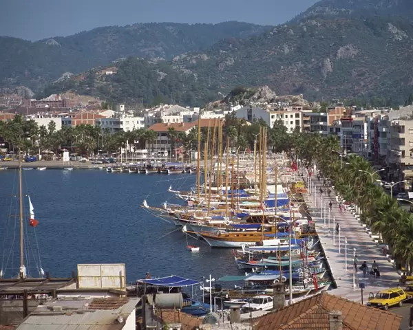 Gulets in the harbour with the town and hills in the background