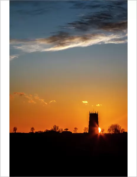Sunset behind the Parish Church of the Holy Trinity and All Saints at Winterton on Sea