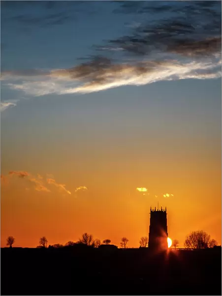 Sunset behind the Parish Church of the Holy Trinity and All Saints at Winterton on Sea