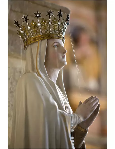 Statue of Virgin Mary wearing crown inside parish church, Saint-Thegonnec, Finistere