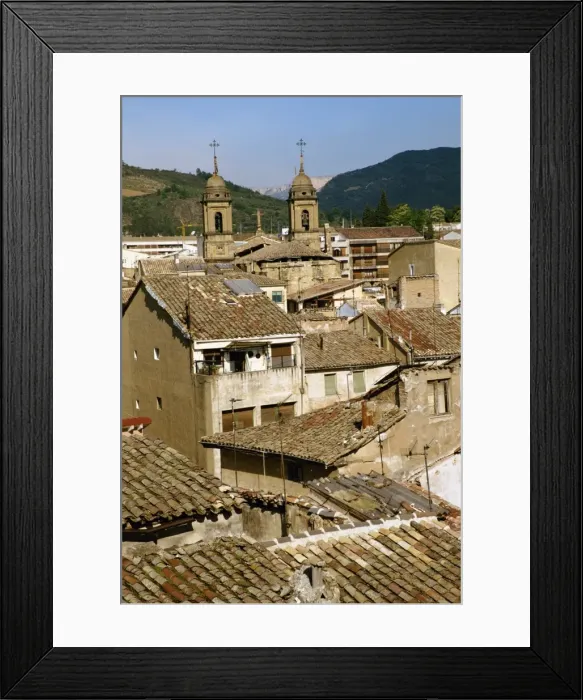 Framed Print : Old buildings with tiled roofs and a church behind Framed Print : Old buildings with tiled roofs and a church behind