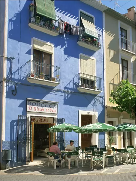 Pavement cafe in front of a blue painted building in Villajoyosa