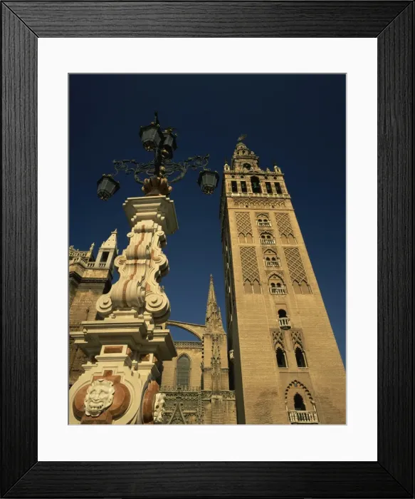 Framed Print : Decorative lamps and the Giralda tower in the city of Seville Framed Print : Decorative lamps and the Giralda tower in the city of Seville