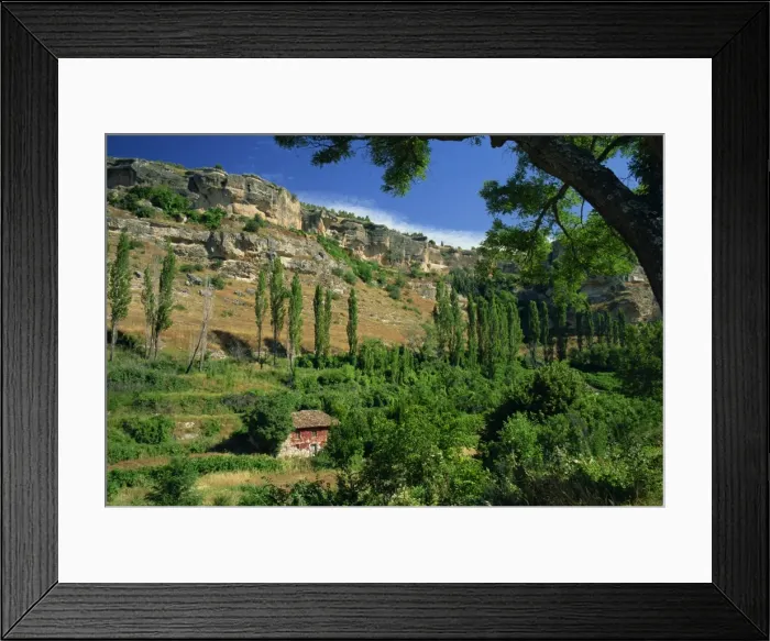 Framed Print : Old house among trees with rock cliffs behind Framed Print : Old house among trees with rock cliffs behind