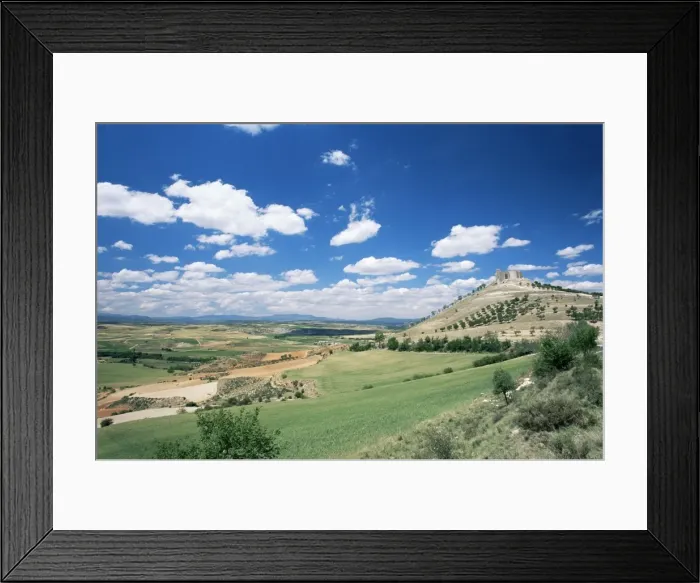 Framed Print : View to castle on hill above fields