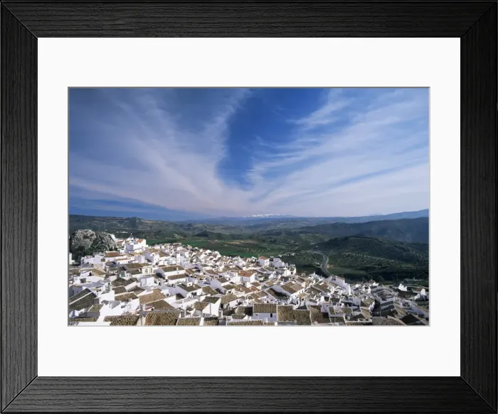 Framed Print : View over village rooftops to distant snow-capped mountains Framed Print : View over village rooftops to distant snow-capped mountains