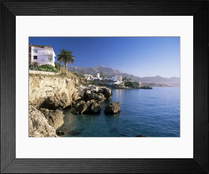 Framed Print : View along rocky coast to town and mountains Framed Print : View along rocky coast to town and mountains