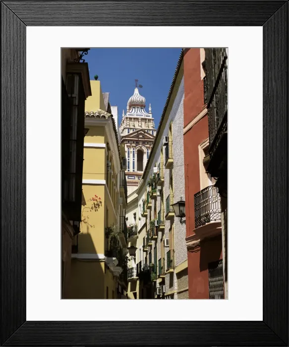 Framed Print : View along narrow street to ornately decorated church Framed Print : View along narrow street to ornately decorated church