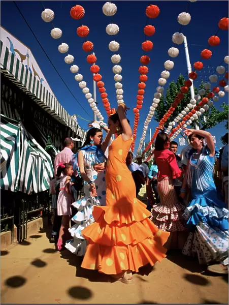 Girls dancing a sevillana beneath colourful lanterns