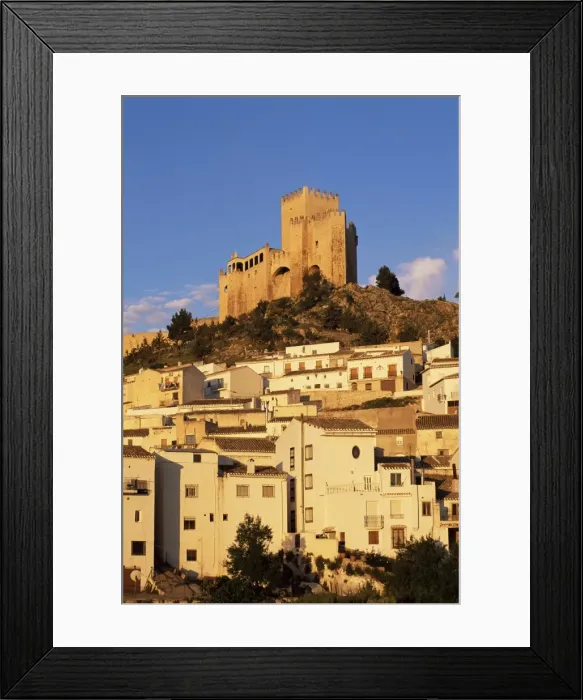 Framed Print : Whitewashed village houses dwarfed by the Castillo Framed Print : Whitewashed village houses dwarfed by the Castillo