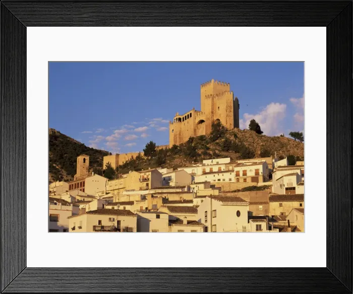 Framed Print : Whitewashed village houses dwarfed by the Castillo Framed Print : Whitewashed village houses dwarfed by the Castillo