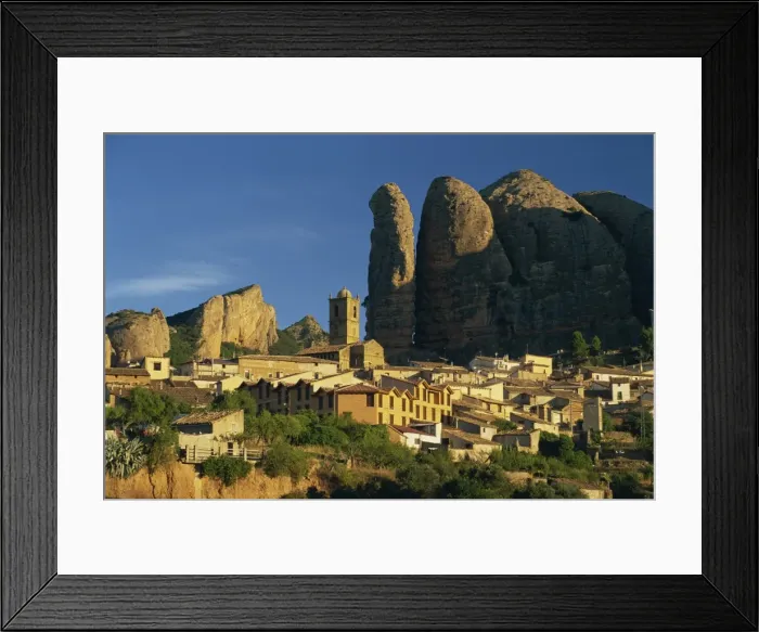 Framed Print : Village dwarfed by the pudding-stone cliffs of Mallos de Aguero Framed Print : Village dwarfed by the pudding-stone cliffs of Mallos de Aguero