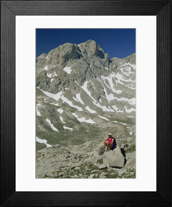 Framed Print : Trekker resting on a rock in the high mountains of Framed Print : Trekker resting on a rock in the high mountains of