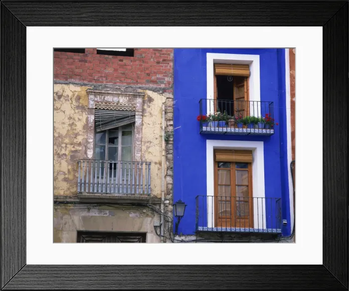 Framed Print : Contrast between derelict and bright blue painted lived Framed Print : Contrast between derelict and bright blue painted lived