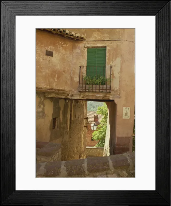 Framed Print : Exterior of old houses on a narrow street in the village