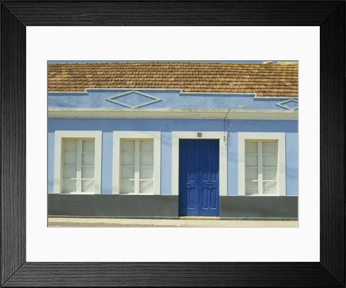 Framed Print : Exterior of a single storey house with blue walls and door Framed Print : Exterior of a single storey house with blue walls and door