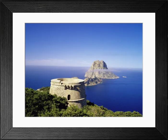 Framed Print : View of defence tower and the rocky island of Es Vedra Framed Print : View of defence tower and the rocky island of Es Vedra