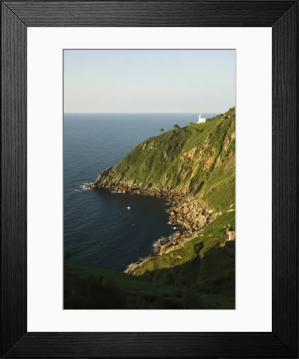 Framed Print : Rocky peninsula with lighthouse on cliff Framed Print : Rocky peninsula with lighthouse on cliff