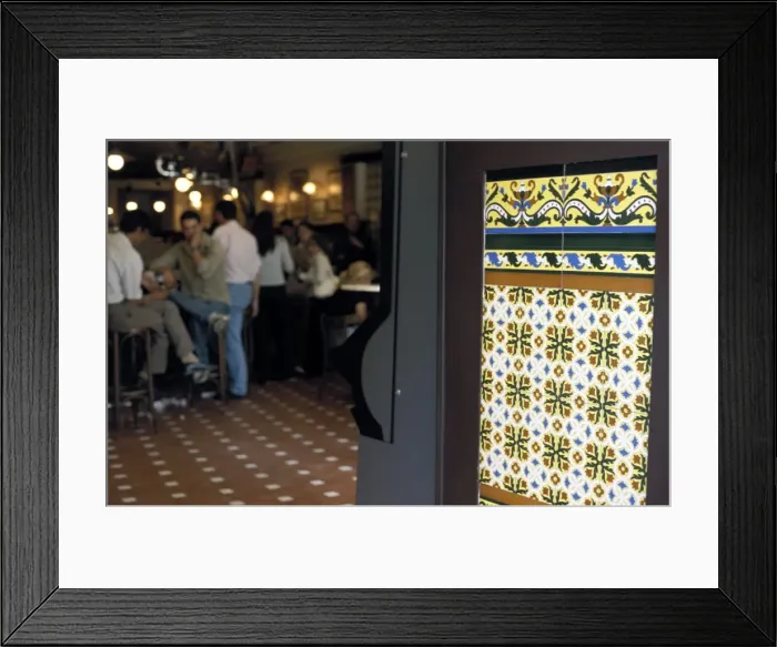 Framed Print : People inside a tapas bar and a detail of decorative tiled wall Framed Print : People inside a tapas bar and a detail of decorative tiled wall
