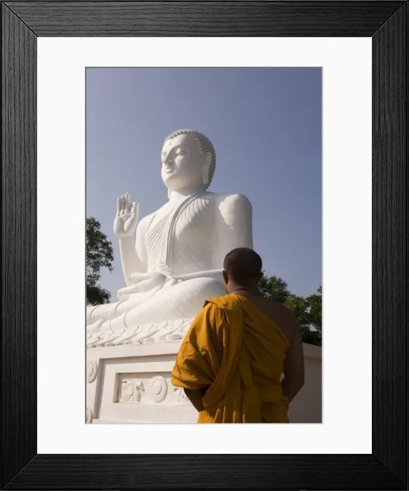 Framed Print : Monk standing in front of the great seated figure of the Buddha Framed Print : Monk standing in front of the great seated figure of the Buddha