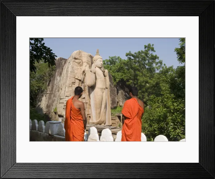 Framed Print : Buddhist monks in front of the giant standing statue