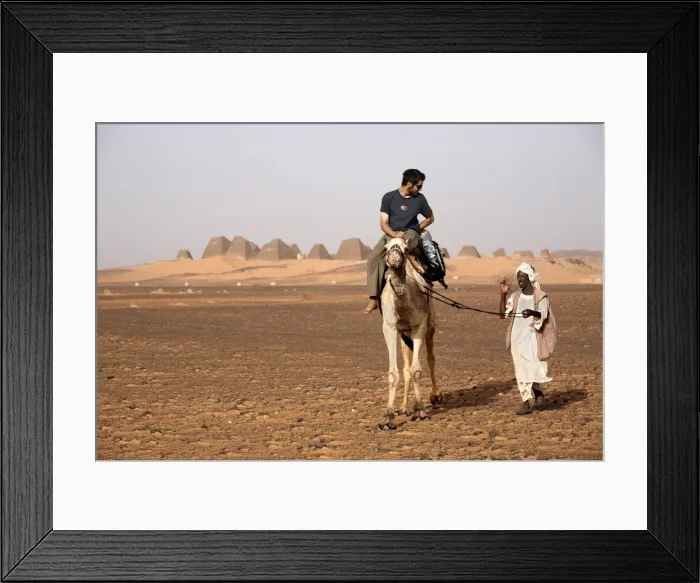 Framed Print : Tourists take camel rides at the pyramids of Meroe Framed Print : Tourists take camel rides at the pyramids of Meroe
