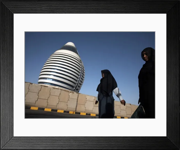 Framed Print : Locals walk past the 5-star Boji Al-Fateh Hotel (Libyan Hotel) Framed Print : Locals walk past the 5-star Boji Al-Fateh Hotel (Libyan Hotel)
