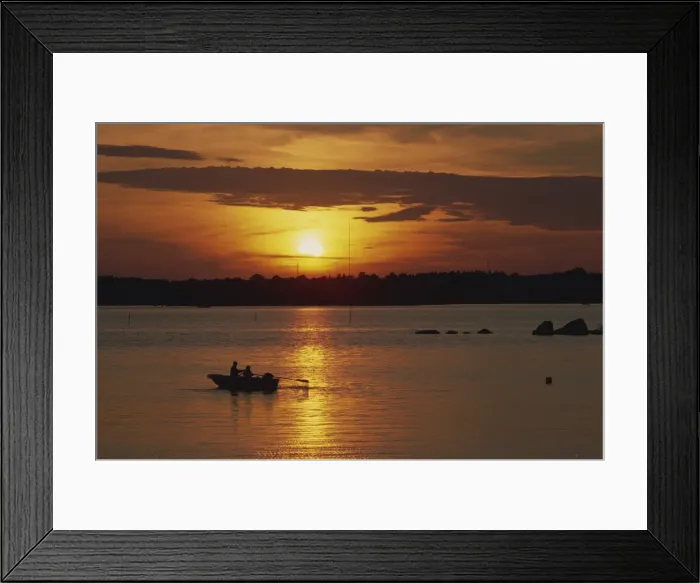Framed Print : Row boat silhouetted over Dragso bay at sunset in summer Framed Print : Row boat silhouetted over Dragso bay at sunset in summer
