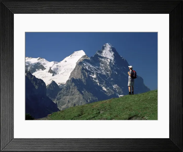 Framed Print : Hiker looking to the snow-covered Monch and the north Framed Print : Hiker looking to the snow-covered Monch and the north