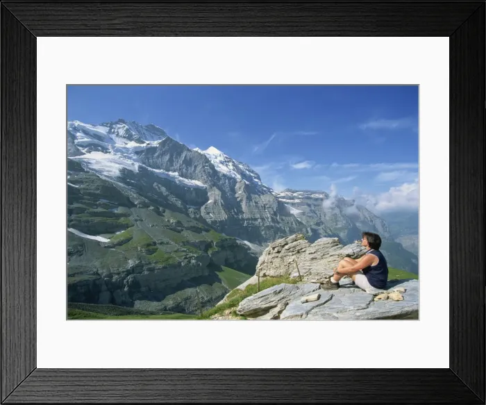 Framed Print : Walker on a rock looking at the Jungfrau peak Framed Print : Walker on a rock looking at the Jungfrau peak